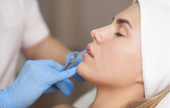 A woman receiving a dermal filler to rejuvenate her skin