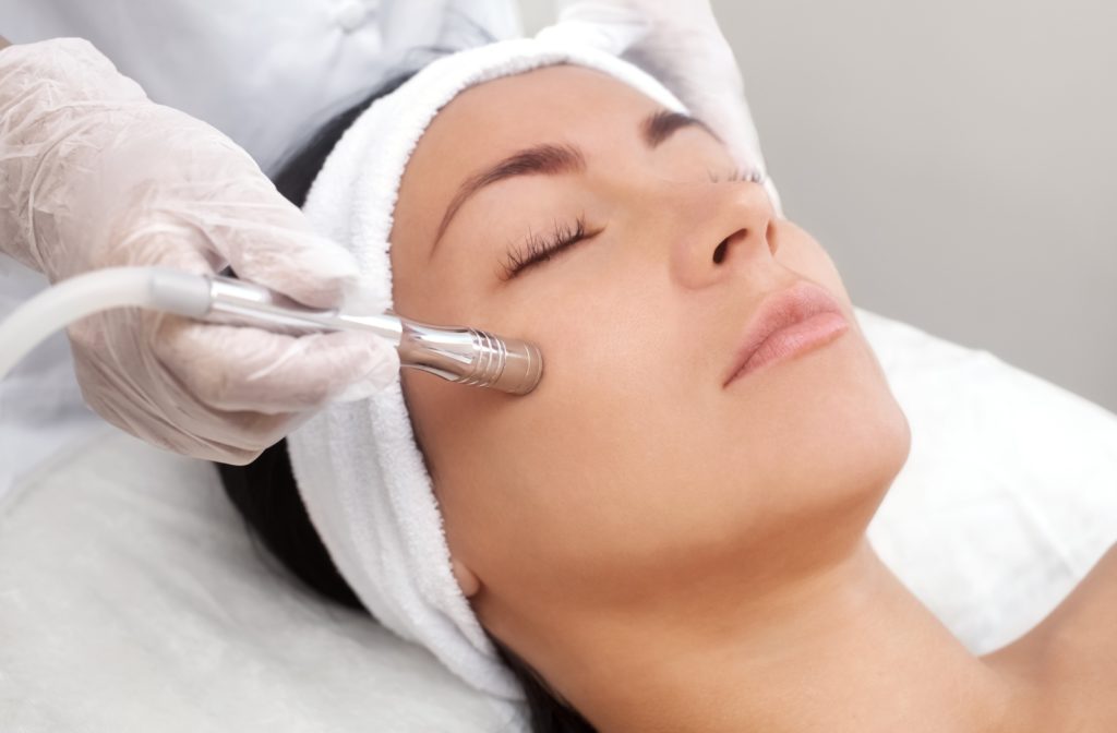 Woman receiving microdermabrasion treatment