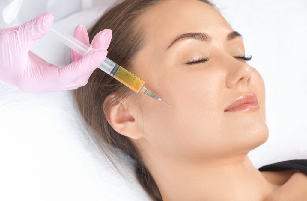 A woman receiving a PRP treatment on her face to rejuvenate her skin