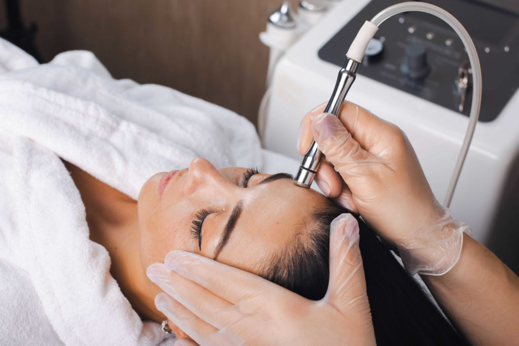 A woman having a microdermabrasion treatment to help rejuvenate her skin