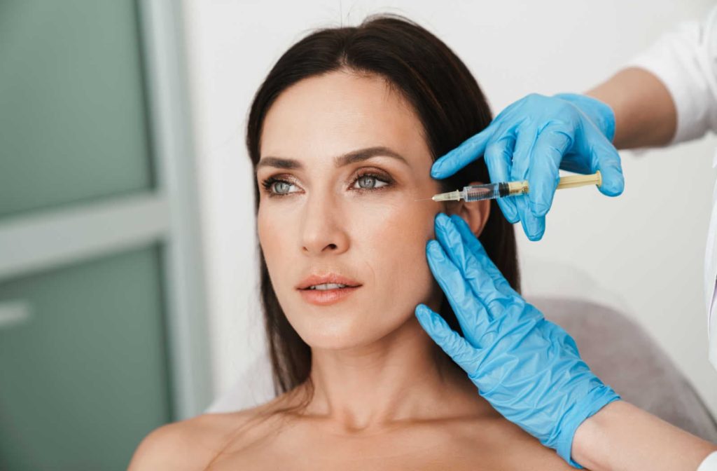 A woman getting a botox from her aesthetician