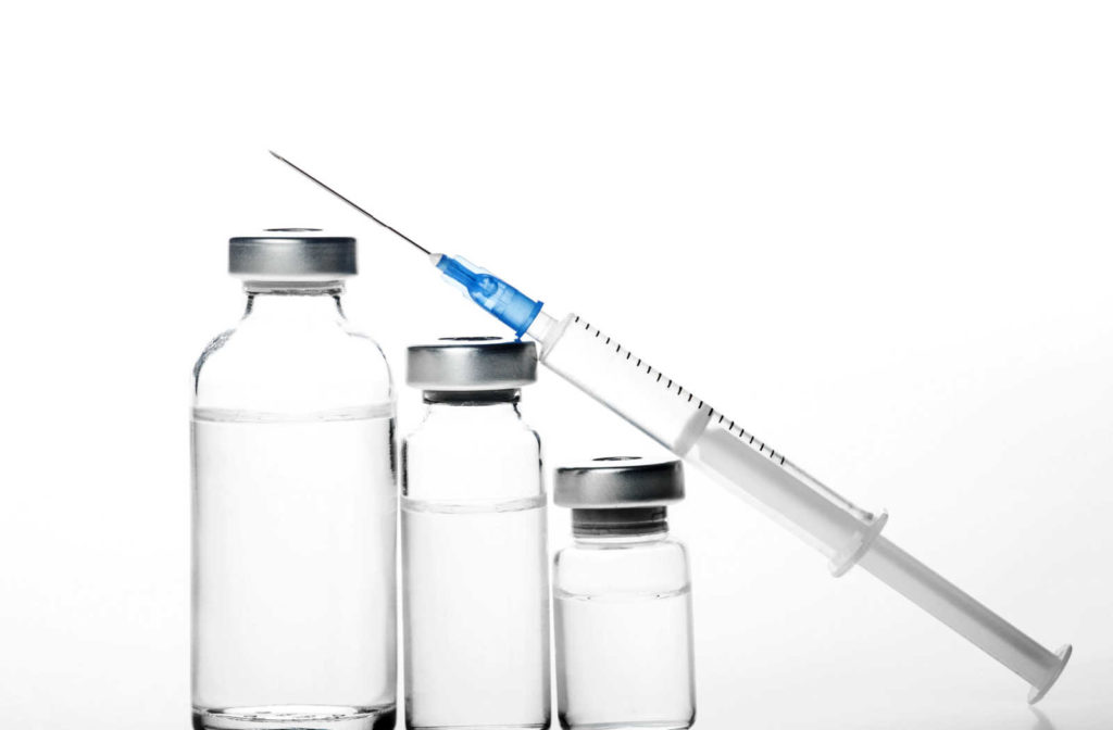 An injection leaning on vials of neuromodulators, including dysport and botox.