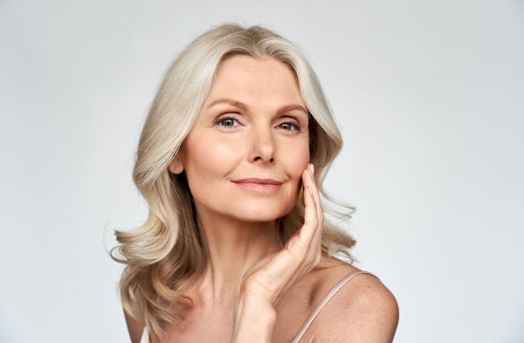 an older woman is feeling the effects of facials to mitigate her sun damage.