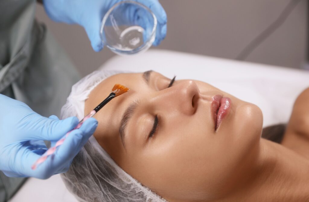 A woman getting a chemical peel from her aesthetician to achieve skin tightening benefits