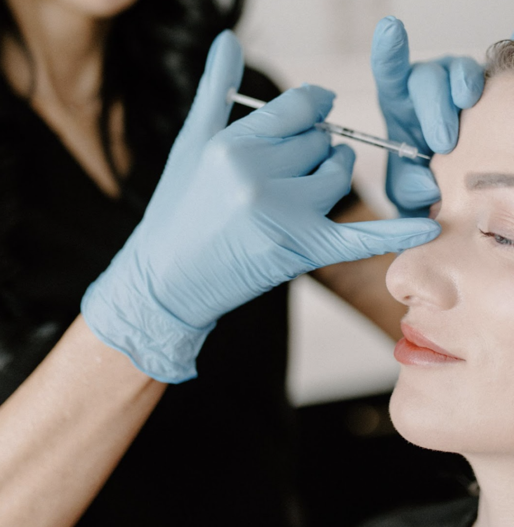 A patient receiving a Botox injection in their forehead.
