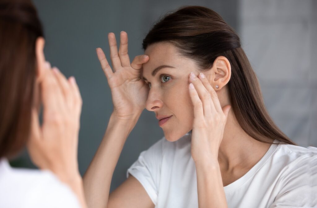 A dermatology patient checking their face for spots and sun damage.