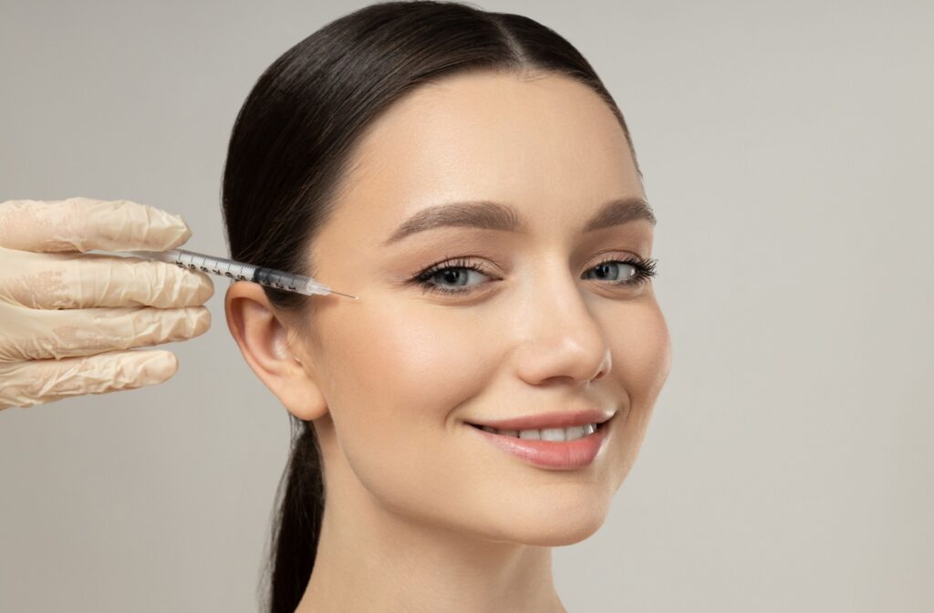 A close up of a person getting botox for their crow's feet wrinkles by their eyes